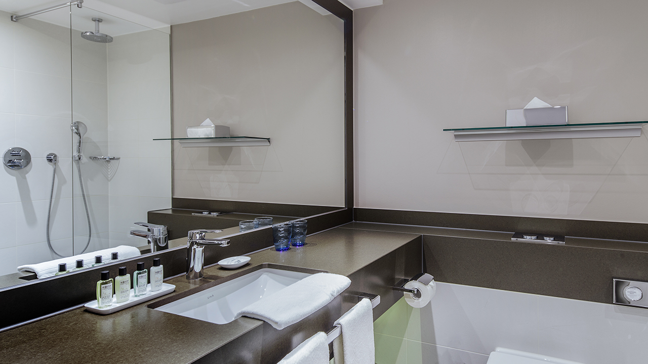 Badezimmer eines Hotelzimmers im The Alex Hotel mit Fön, Heizung und Waschbecken